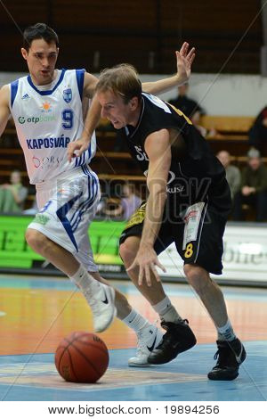 KAPOSVAR, HUNGARY - JANUARY 22: Laszlo Kalman (in black) in action at a Hungarian National Championship basketball game Kaposvar vs Szombathely January 22, 2011 in Kaposvar.
