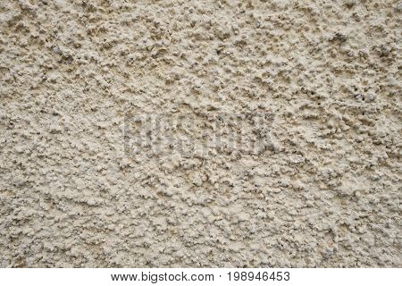 Background texture yellow plaster of the old wall. Close-up.