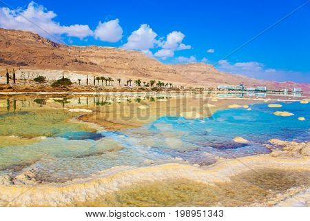  The evaporated salt. Reduced water in the very salty Dead Sea. Dead Sea, Israel. The concept of medical and ecological tourism