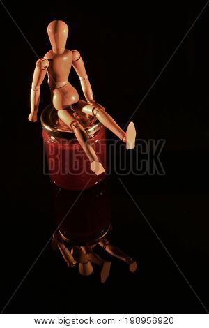 Canned fruit with wooden doll and black background