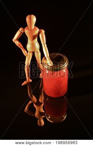 Canned fruit with wooden doll and black background