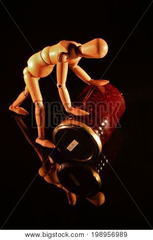 Canned fruit with wooden doll and black background