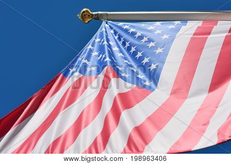 Waving flag of the USA on blue sky