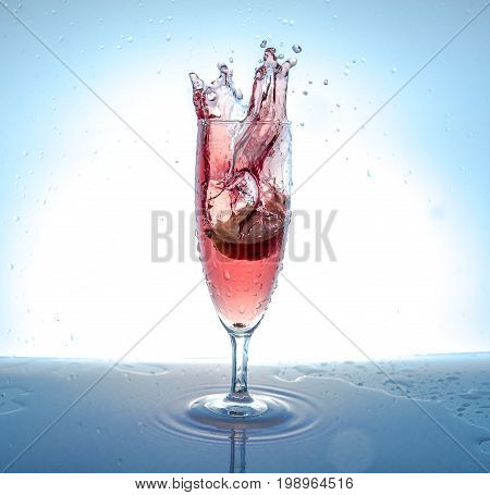 Apple Pieces Falling Into A Glass With Water