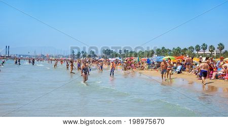 SALOU, SPAIN - AUGUST 3, 2017: Vacationers in the Llevant Beach in Salou, Spain. Salou is a major destination for sun and beach for European tourism, with more than 50,000 accommodations
