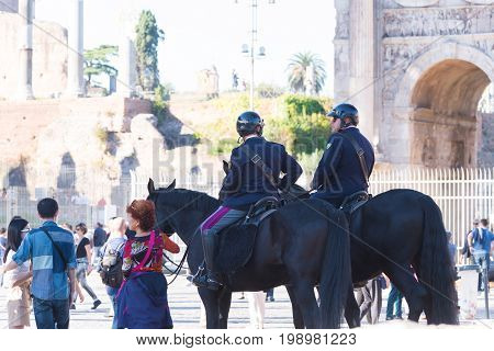 ROME ITALY - OCTOBER 16 2016: Two italian police men on horses at the collosseum