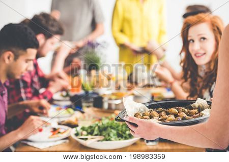Vegetarian shares baked potatoes with vegan friends during vege meeting at home