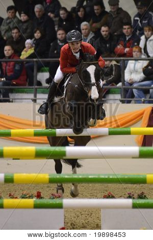 KAPOSVAR, HUNGARY - MARCH 27: Laszlo Toth jumps with his horse (Masni) on the Masters Tournament International Jumping Competition, March 27, 2011 in Kaposvar, Hungary