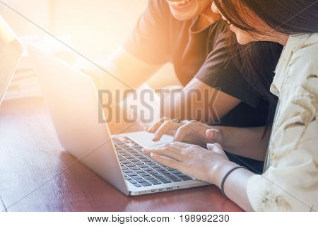 young people being used computer.education technology and internet concept - two smiling students with laptop.