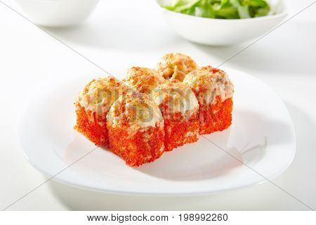 Hot Tobiko Maki Sushi - Sushi Roll Topped with Baked Cheese and Tobiko. Tobiko outside