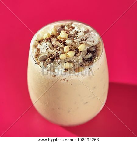 Nuts and Banana Smoothie on Bright Pink Background