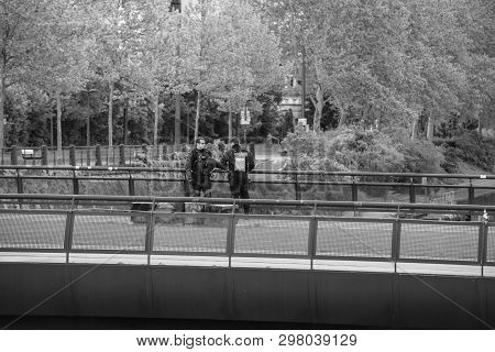 Strasbourg, France - Apr 28, 2019: Two Crs Police Officers Surveilling The Bridge Near European Parl