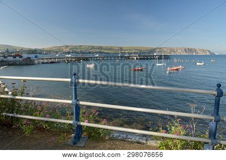 The Seafront At Swanage On The Dorset Coast Looking Across The Bay From Peveril Point