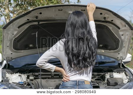 Young Woman Broken Car And Open Hood During The Trip On The Roadside. She Opened The Hood Broken Car