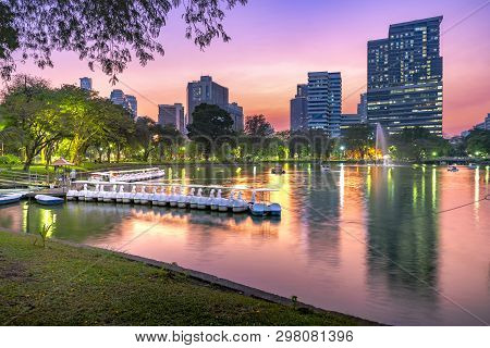 Lumpini Park In Bangkok At Night, Thailand. Landscape View Of Lakeside At Lumpini Park, Where People