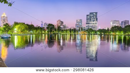 Lumpini Park In Bangkok At Night Panorama Concept. Thailand. Landscape View Of Lakeside At Lumpini P