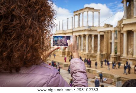 Tourist Girl Taking A Picture In The Antique Roman Theatre Of Merida, Spain.