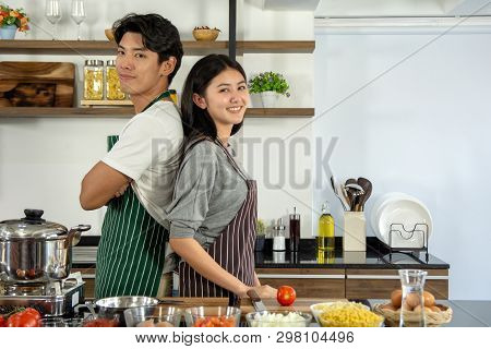 Portrait Of Cute Happy Couple In Aporn Jposting To Prepare Breakfast Decorated With Salad In Modern 
