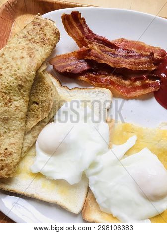Big Breakfast With Poached Eggs, Crispy Bacon, Toast And Oatcakes