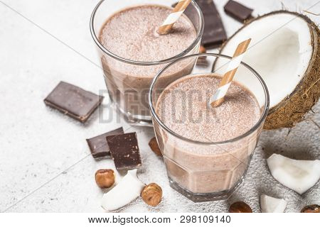 Chocolate Coconut Hazelnut Milkshake Or Smoothie In Two Glasses On White Table.