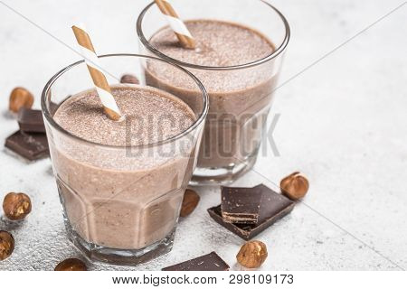 Chocolate Coconut Hazelnut Milkshake Or Smoothie In Two Glasses On White Table.
