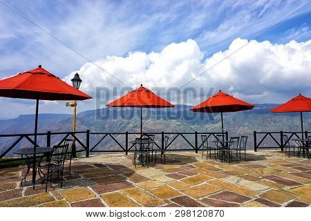 View Of Balcony With Red Umbrellas In Chicamocha National Park In Santander, Colombia