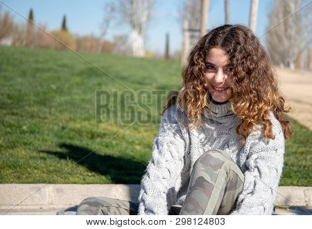 Portrait Of A Pre-adolescent Girl Posing In A Public Park On A Sunny Spring Day