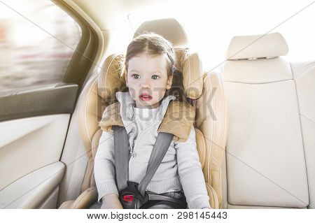 Child In A Baby Car Seat. Isofix Clamping. Beige Car Seat In A Bright Salon. Protection In The Car.