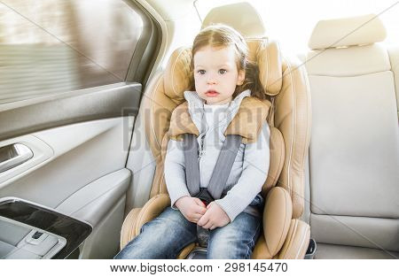 Child In A Baby Car Seat. Isofix Clamping. Beige Car Seat In A Bright Salon. Protection In The Car.