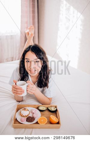 Young Woman Eating Healthy Breakfast In Bed