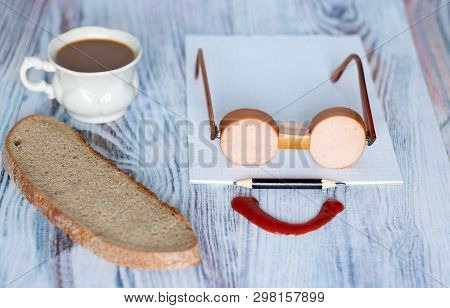 Breakfast. Bread, Coffee And Sausage Laid In An Original Way.
