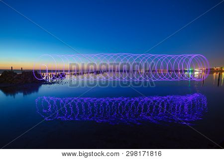 Amazing Laser Fireshow Performance In The Night Blue Sky With Reflections In The Sea Water