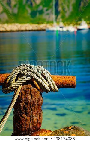Harbor Marina Detail. Old Rusty Mooring Bollard With Rope. Bleik Village, Andoya Island, Vesteralen 