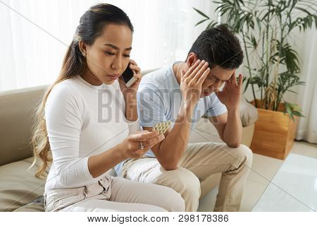 Vietnamese Woman Discussing Contraindications Of Painkillers On The Phone