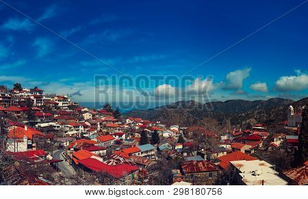 Pedoulas Village On Cyprus In Troodos Mountains With Blue Sky And Copy Space. Panoramic View.