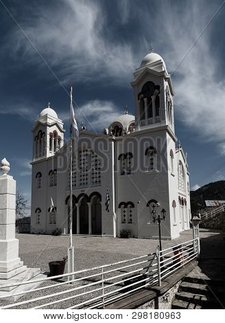 Church Of Holy Cross With Blue Sky And White Clouds In Pedoulas Village. Nicosia District, Cyprus. T