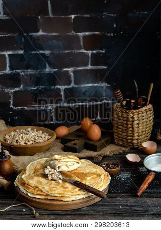 Homemade Stack Of Crepes With Ground Fried Meat On Top On Wood Plate Stand On Rustic Table With Plat