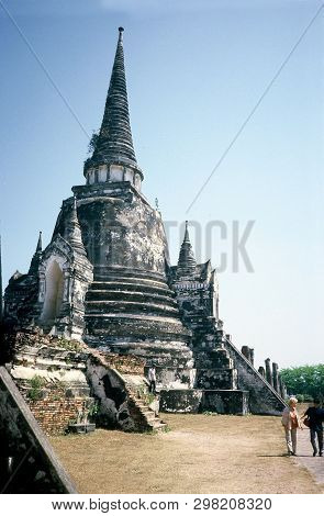 Ayutthaya / Thailand - Circa 2000: Tourists Visit A Buddhist Stupa Among The Ancient Ruins Of Wat Ph
