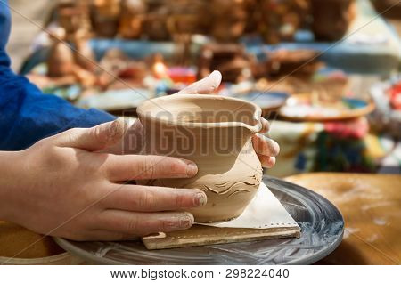 Hands Of A Potter Making Ceramic Clay Product On The Pottery Whee.