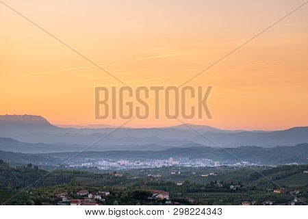 View Over Vineyards In Wine Region Brda On Sunrise To Town Nova Gorica With Julian Alps And Triglav 