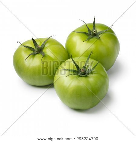 Three fresh green unripe tomatoes isolated on white background