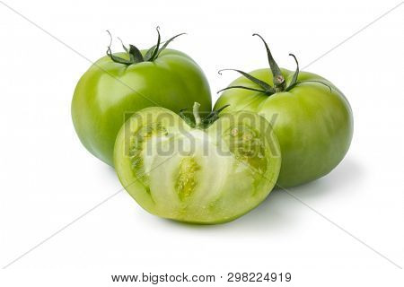 Whole and halved fresh green unripe tomatoes isolated on white background