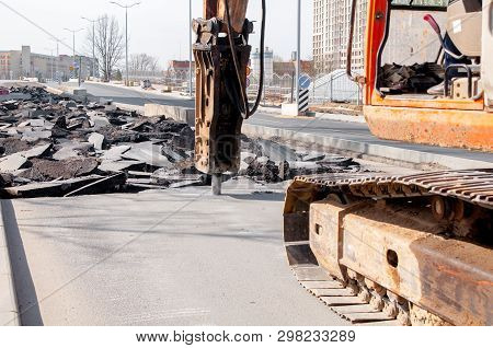 Machine Drills Asphalt. Large Fragments Of Land And Pits Everywhere On The Road. Working Equipment W