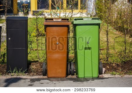 Close Up View Of Typical Garbage Containers For Organig And Non-organic Garbage Sorting Near Black P
