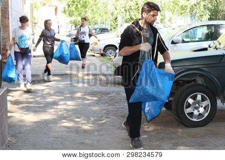 Plogging. Girls Run And Collect Garbage In Bags On The Streets Saratov, Russia, 10 June 2018