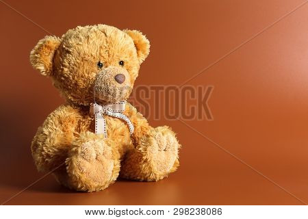 Soft Warm Cute Brown Teddy Bear On Color Background. Isolated. Soft Brown Coffee Background. Copy Sp