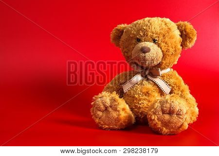 Soft Warm Cute Brown Teddy Bear On Color Backgroung. Isolated. Soft Red Background. Copy Spase For T