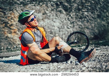 The Biker Fell From A Bike, Using A Bandage From His First Aid Kit To Help Himself. Bicycle Accident