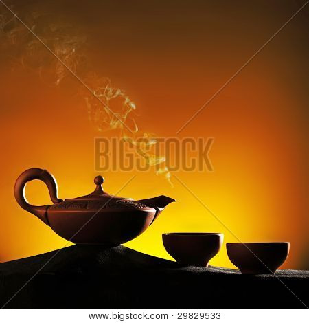 Arabian matte brown teapot with bowls on a hills