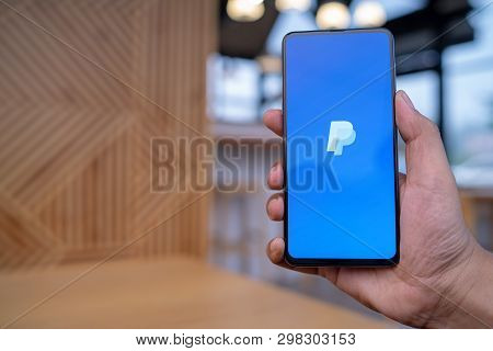 Chiang Mai, Thailand - Mar. 23,2019: Man Holding Xiaomi Mi Mix 3 With Paypal Apps On The Screen. Pay